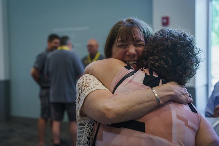 Friends embrace in a hug during reunion